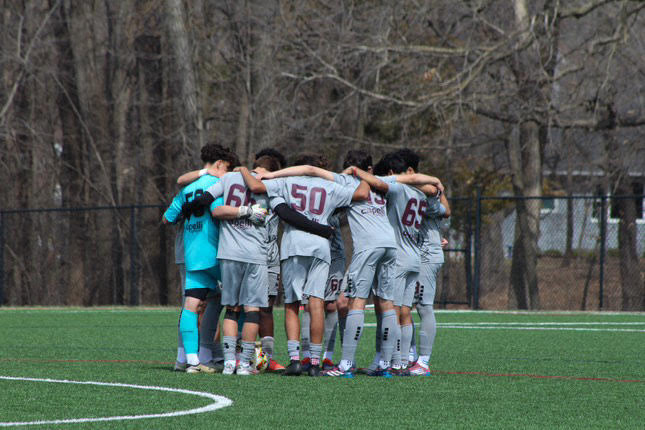 Boys U14 team huddles midgame.