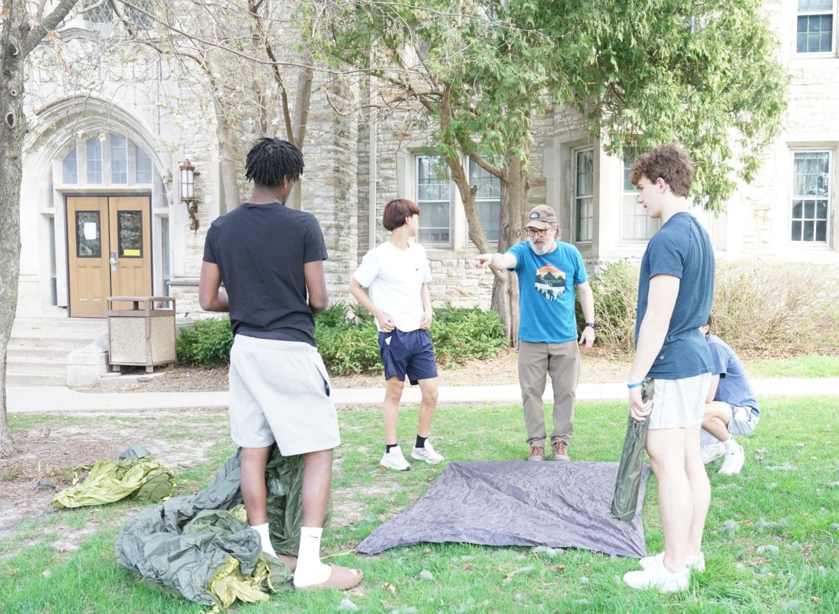 Mr. Peter Scheilf is directing a group students on tent set up.